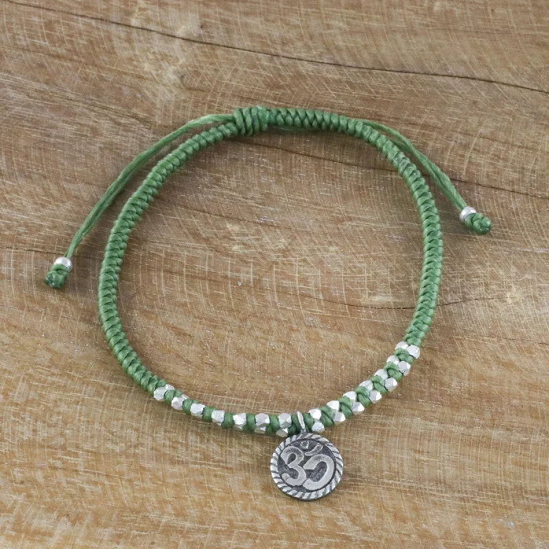 trendy bracelets for special events with sapphires -Ancient Om in Green Silver Om Charm Bracelet on Braided Green Cords